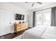 Comfortable main bedroom with mounted tv, ceiling fan, and balcony access at 519 Sutherland Ave, Indianapolis, IN 46205