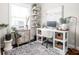 Bright office area with large desk, shelves, stylish decor, and decorative rug at 519 Sutherland Ave, Indianapolis, IN 46205