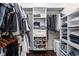 Organized walk-in closet with custom shelving, hanging rods, shoe racks, and dark wood floors at 519 Sutherland Ave, Indianapolis, IN 46205