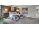 Primary bedroom with wood-paneled accent wall, two chairs, and decorative art at 5343 Pelion Pl, McCordsville, IN 46055
