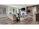 Bright living room featuring fireplace, wood accent wall, large windows, and comfortable modern furnishings at 5343 Pelion Pl, McCordsville, IN 46055