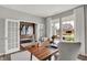 Inviting study with wood floors, white French doors, a large window, and a view of the neighborhood at 5343 Pelion Pl, McCordsville, IN 46055