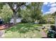 Lush backyard featuring a deck area and fire pit surrounded by mature trees at 5363 Primrose Ave, Indianapolis, IN 46220