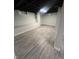 Finished basement with modern flooring, an exposed dark ceiling, and bright lighting at 5363 Primrose Ave, Indianapolis, IN 46220