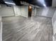 Spacious basement with durable vinyl flooring, white walls, and a dark painted ceiling at 5363 Primrose Ave, Indianapolis, IN 46220