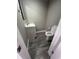 Compact powder room featuring a modern sink and toilet with gray walls and flooring at 5363 Primrose Ave, Indianapolis, IN 46220