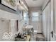 Updated bathroom with white tiles, traditional fixtures, and a window for natural light at 5363 Primrose Ave, Indianapolis, IN 46220