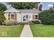 Inviting exterior of home showcasing the landscaped front yard, sidewalk, and charming architectural details at 5363 Primrose Ave, Indianapolis, IN 46220