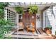 Inviting front porch with chairs, lush greenery, and a decorative wreath on the door at 5363 Primrose Ave, Indianapolis, IN 46220