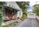 Charming home featuring a covered porch with seating and a detached garage at 5363 Primrose Ave, Indianapolis, IN 46220