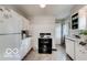 Classic kitchen featuring white cabinetry, appliances, and plenty of counter space at 5363 Primrose Ave, Indianapolis, IN 46220