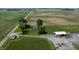 Aerial view featuring a home, outbuilding, and surrounding farmland in a rural setting at 5396 N 1000 E, Sheridan, IN 46069