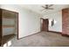 Bedroom featuring carpet floors, red brick accents, closet and access to a bathroom at 5396 N 1000 E, Sheridan, IN 46069