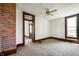 Well-lit bedroom featuring carpet, brick detail, ceiling fan, and large window at 5396 N 1000 E, Sheridan, IN 46069