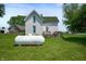 Charming white two-story farmhouse with a green roof and spacious yard at 5396 N 1000 E, Sheridan, IN 46069