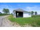 Rustic white storage shed with open framing on grass; needs renovation at 5396 N 1000 E, Sheridan, IN 46069