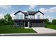 Charming two-story home with black accents, a well-manicured lawn, and a two car attached garage at 588 Arkansas Ln, Westfield, IN 46074