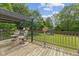 View of the backyard from the deck, featuring chairs, a covered area, and lawn at 618 Shady Creek Dr, Greenwood, IN 46142