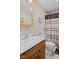 Modest bathroom with a toilet, vanity sink and a shower with a striped and patterned curtain at 618 Shady Creek Dr, Greenwood, IN 46142