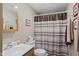 Modest bathroom with a toilet, vanity sink and a shower with a striped and patterned curtain at 618 Shady Creek Dr, Greenwood, IN 46142