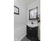 Charming half-bathroom with a black vanity, modern faucet, and beadboard walls at 618 Shady Creek Dr, Greenwood, IN 46142