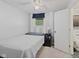 Minimalist bedroom features a bed, bedside table, and view out the window at 618 Shady Creek Dr, Greenwood, IN 46142