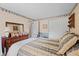 View of the guest bedroom with dark wood furnishings and decorated with a diamond-pattern wallpaper border at 618 Shady Creek Dr, Greenwood, IN 46142