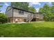 Exterior shot of the back of the house featuring a deck, patio, and grassy backyard at 618 Shady Creek Dr, Greenwood, IN 46142