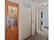 Hallway with carpeted floors and a built-in glass cabinet featuring a collection of hummingbird figurines at 618 Shady Creek Dr, Greenwood, IN 46142