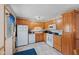 Functional kitchen with oak cabinets, white appliances, and neutral countertops at 618 Shady Creek Dr, Greenwood, IN 46142