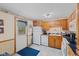 Kitchen includes white appliances, wood cabinets, and access to a back door at 618 Shady Creek Dr, Greenwood, IN 46142