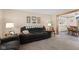 Comfortable living room features a plush sofa and a view into the dining area at 618 Shady Creek Dr, Greenwood, IN 46142