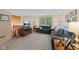 Cozy living room features comfortable seating, a large TV, and neutral carpeting at 618 Shady Creek Dr, Greenwood, IN 46142