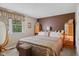A warm, inviting bedroom featuring a queen-size bed and wooden accents, illuminated by soft bedside lighting at 618 Shady Creek Dr, Greenwood, IN 46142