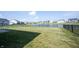 Large backyard with expansive lawn, iron fence and serene pond views at 6218 N Woodside Ct, McCordsville, IN 46055