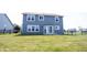 The fenced backyard has an expansive lawn, a patio, and a view of the home at 6218 N Woodside Ct, McCordsville, IN 46055