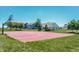 Community basketball court next to grass with trees and neighborhood homes in the background at 6218 N Woodside Ct, McCordsville, IN 46055