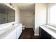 Bright bathroom featuring double sinks, a large mirror, and a walk-in shower at 6218 N Woodside Ct, McCordsville, IN 46055