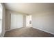 Neutral bedroom with carpet, closet and open door leading to a hallway at 6218 N Woodside Ct, McCordsville, IN 46055