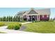 Clubhouse with manicured lawn, black metal fence, flowers and greenery at 6218 N Woodside Ct, McCordsville, IN 46055