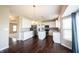 Spacious kitchen features white cabinets, stainless appliances, granite countertops, an island, and hardwood floors at 6218 N Woodside Ct, McCordsville, IN 46055