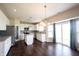 Bright kitchen with white cabinets, stainless steel appliances, a central island, and sliding glass doors for lots of natural light at 6218 N Woodside Ct, McCordsville, IN 46055