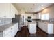 Lovely kitchen with white cabinets, a pantry, stainless appliances, a granite topped island, and backsplash at 6218 N Woodside Ct, McCordsville, IN 46055
