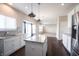 Bright kitchen featuring white cabinets, stainless appliances, granite countertops, and an island that adds workspace at 6218 N Woodside Ct, McCordsville, IN 46055