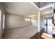 Spacious living room featuring neutral walls, plush carpeting, ample natural light, and decorative lighting fixtures at 6218 N Woodside Ct, McCordsville, IN 46055