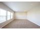 Bright, open living room with neutral carpet, recessed lighting, and large windows for natural light at 6218 N Woodside Ct, McCordsville, IN 46055