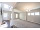 Well-lit living room features soft carpeting, hardwood flooring, a staircase, and ample natural light through large windows at 6218 N Woodside Ct, McCordsville, IN 46055