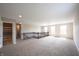 Expansive loft area featuring soft carpeting, a connecting hallway, and lots of light from the windows at 6218 N Woodside Ct, McCordsville, IN 46055