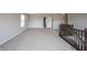 Spacious upper level landing area with neutral carpet and banister overlooking the stairs at 6218 N Woodside Ct, McCordsville, IN 46055