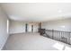 Carpeted upper level loft space with a view of the staircase and a partially visible bathroom at 6218 N Woodside Ct, McCordsville, IN 46055